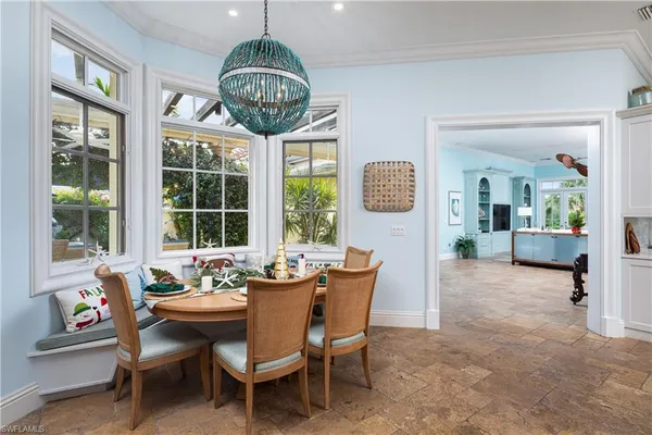 a dining room with furniture a livingroom and chandelier