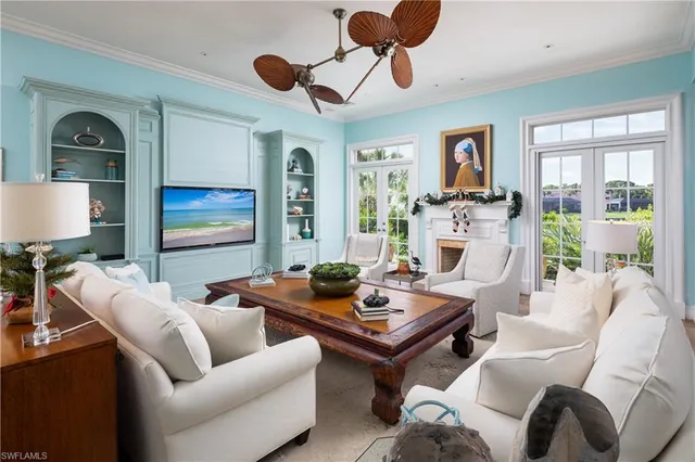 a living room with furniture ceiling fan and a window