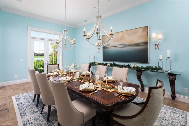 a dining room with furniture a chandelier and wooden floor