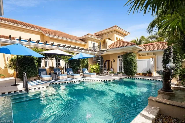 a view of a house with swimming pool and sitting area