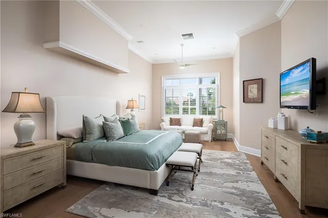 a bedroom with furniture and a flat screen tv