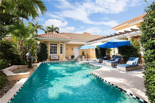 a view of a lake with a big yard and potted plants