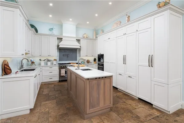 a kitchen with granite countertop a white stove top oven and cabinets