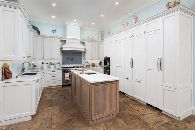 a kitchen with granite countertop a white stove top oven and cabinets