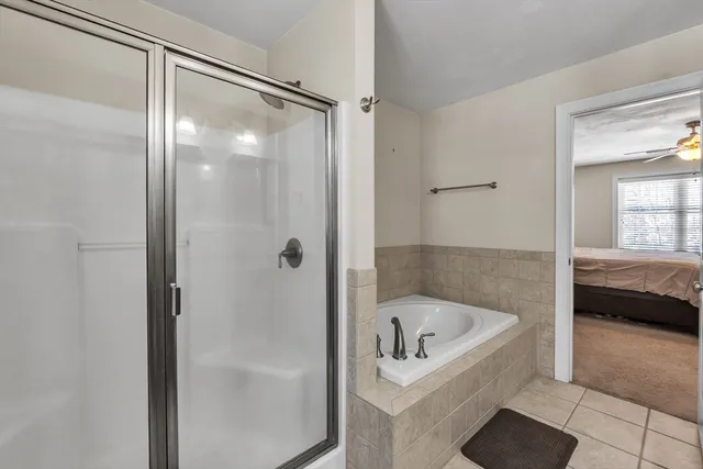 a bathroom with a tub and a shower