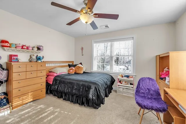 a bedroom with a bed dresser and a window