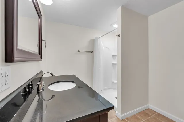a bathroom with a sink and mirror