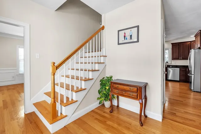 a view of front door with wooden floor and a rug