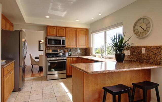 751 Skyview Drive Santa Barbara, CA 93108 - Photo 8 of 31 a kitchen with cabinets a sink and a stove top oven with wooden floor