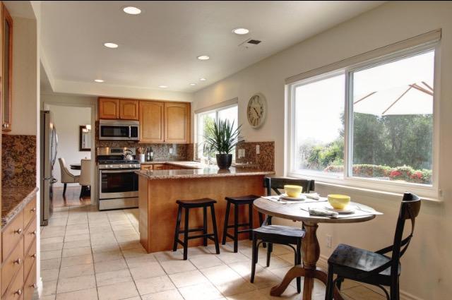 751 Skyview Drive Santa Barbara, CA 93108 - Photo 9 of 31 a kitchen with a table chairs microwave and cabinets