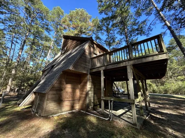 a view of a house with large windows and a small yard
