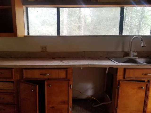 a view of a room with wooden floor and furniture