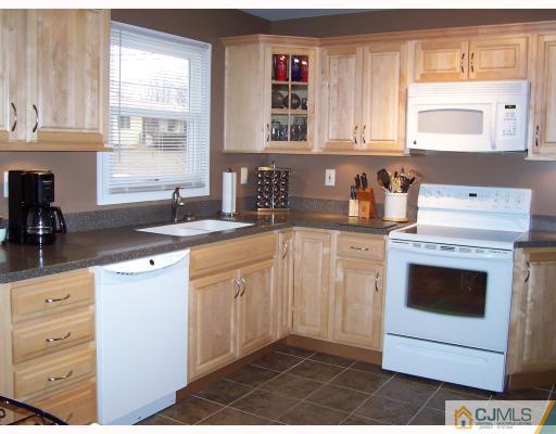 55 Princeton Road Old Bridge, NJ 08859 - Photo 3 of 7 a kitchen with granite countertop a sink a stove and cabinets