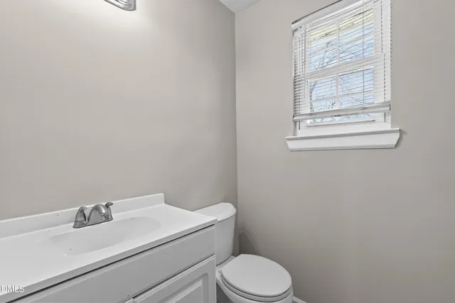 a white toilet sitting next to a bathroom sink