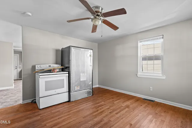 a kitchen with white cabinets and white appliances