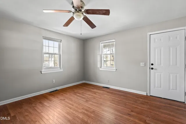 wooden floor in an empty room with a window