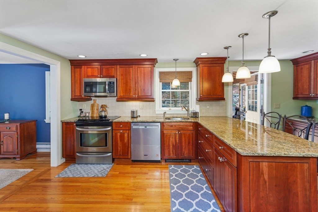 40 Breakneck Road Sturbridge, MA 01566 - Photo 11 of 39 a kitchen with stainless steel appliances granite countertop a sink stove and refrigerator