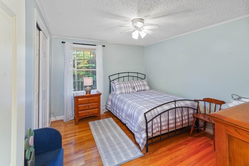 40 Breakneck Road Sturbridge, MA 01566 - Photo 16 of 39 a bedroom with a bed and wooden floor