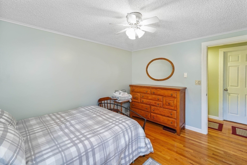 40 Breakneck Road Sturbridge, MA 01566 - Photo 17 of 39 a bedroom with a bed and a chandelier