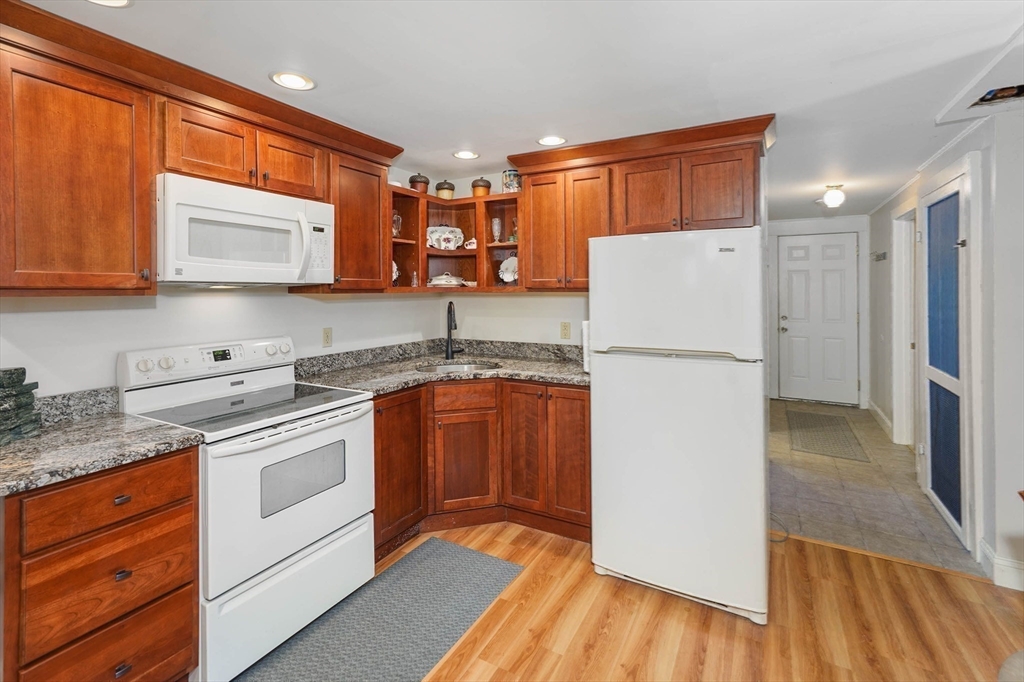 40 Breakneck Road Sturbridge, MA 01566 - Photo 25 of 39 a kitchen with granite countertop a refrigerator stove and sink