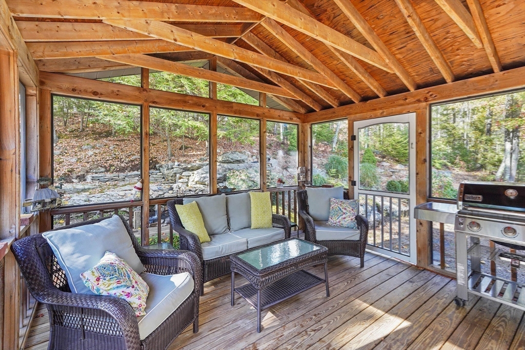 40 Breakneck Road Sturbridge, MA 01566 - Photo 29 of 39 a living room with furniture a wooden floor and a large window