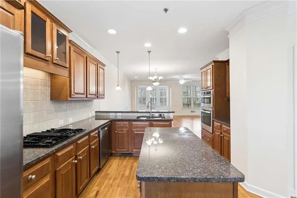 a kitchen with stainless steel appliances granite countertop a stove and a sink