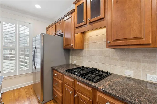 a kitchen with stainless steel appliances granite countertop a stove and a refrigerator