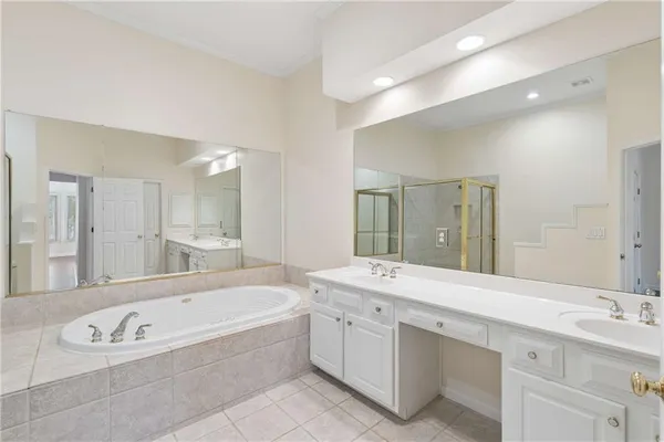 a bathroom with a bathtub a double vanity sink a double vanity
