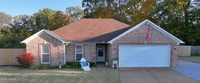 a view of a house with a yard and garage