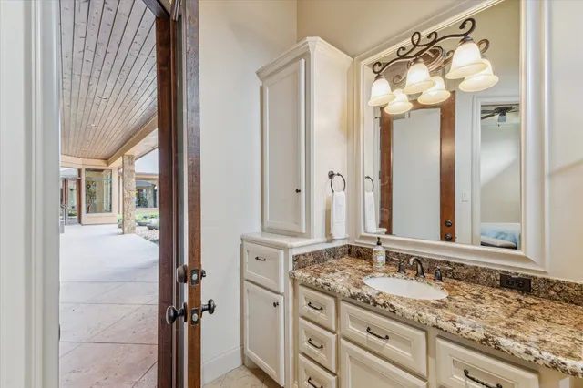 a bathroom with a granite countertop sink mirror and a shower