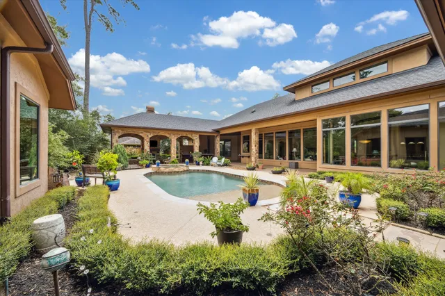 a view of a house with swimming pool and sitting area