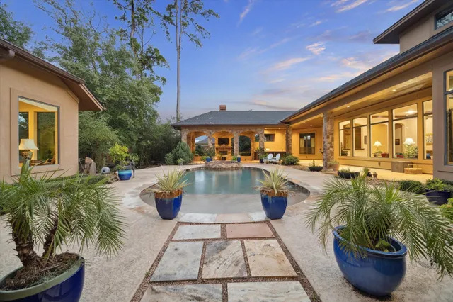 a view of a swimming pool with outdoor seating