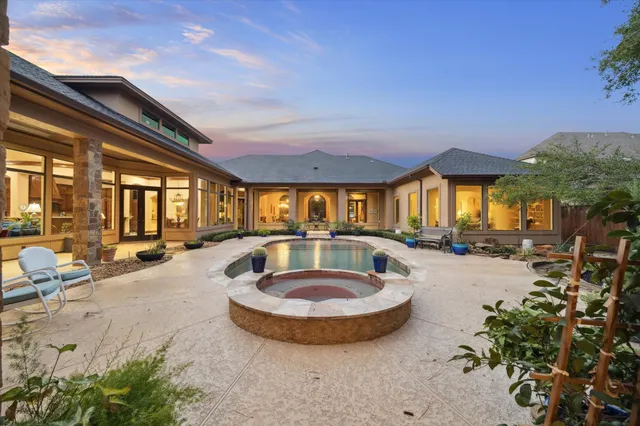 a view of a house with swimming pool and sitting area