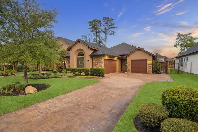 a bathroom with a granite countertop sink a mirror and a toilet