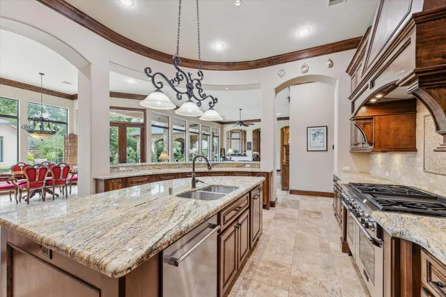 a kitchen with stainless steel appliances granite countertop a stove and a wooden cabinets