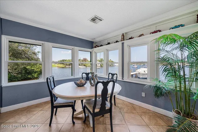 a kitchen with a table chairs sink and cabinets