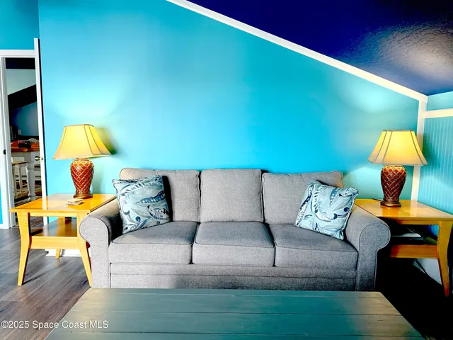 a view of a livingroom with furniture and a ceiling fan