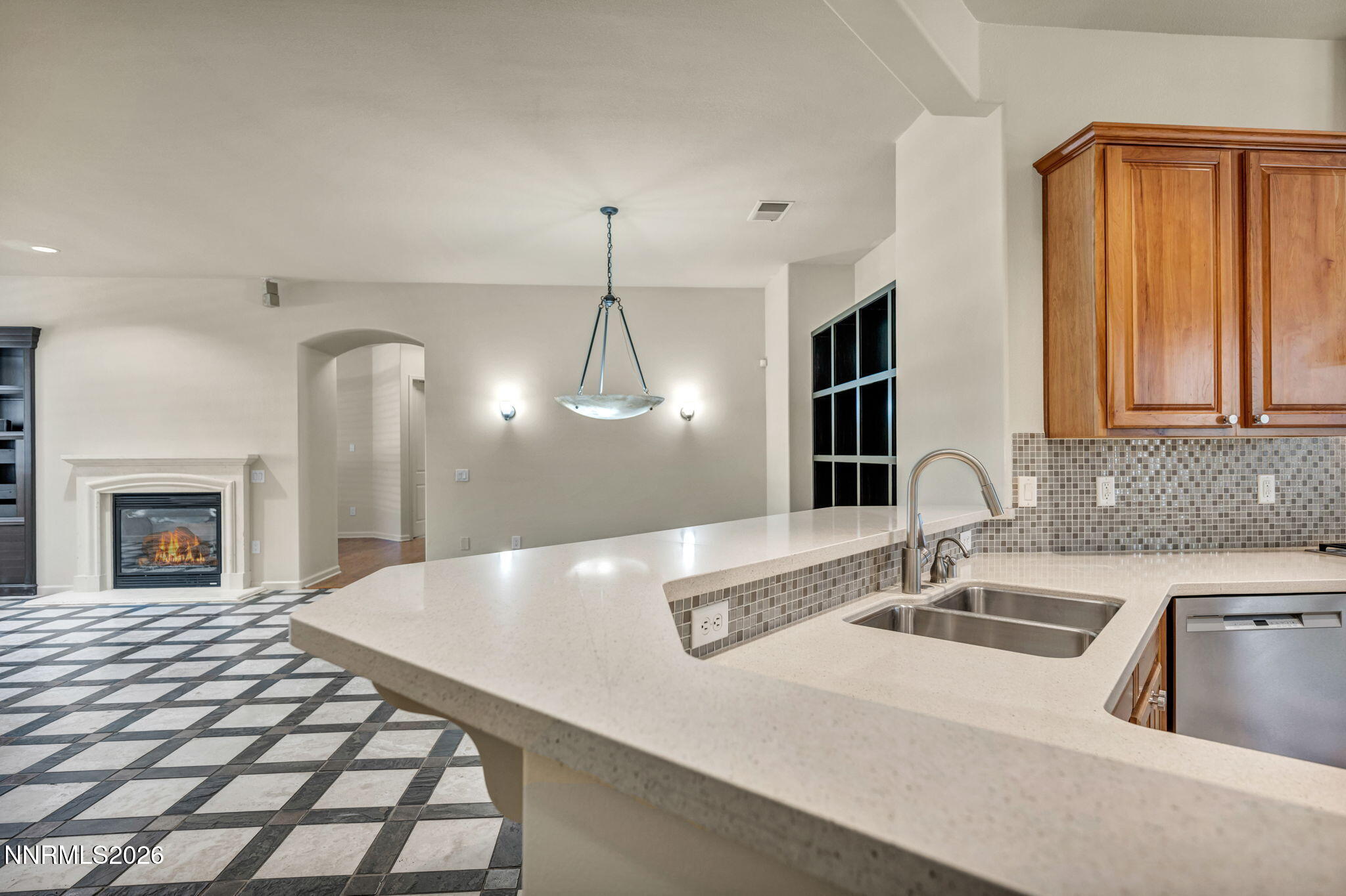 9900 Wilbur May Parkway, Unit 2801 Reno, NV 89521 - Photo 13 of 70 a kitchen with a sink and a fireplace
