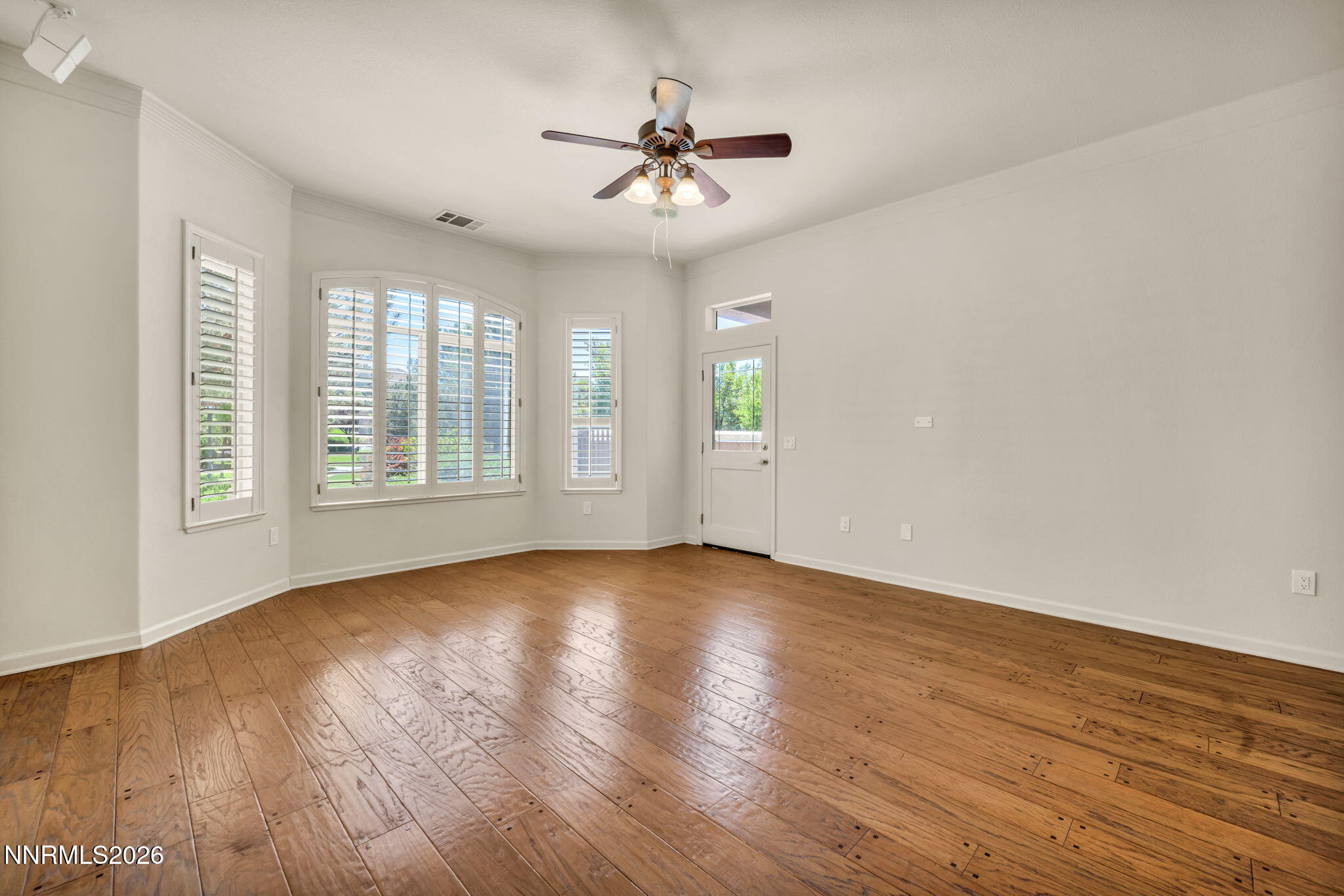 9900 Wilbur May Parkway, Unit 2801 Reno, NV 89521 - Photo 32 of 70 an empty room with wooden floor chandelier fan and windows