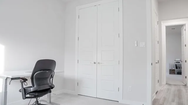 a room with a chair and a potted plant