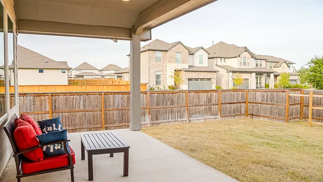 a view of a balcony with a floor to ceiling window next to a yard