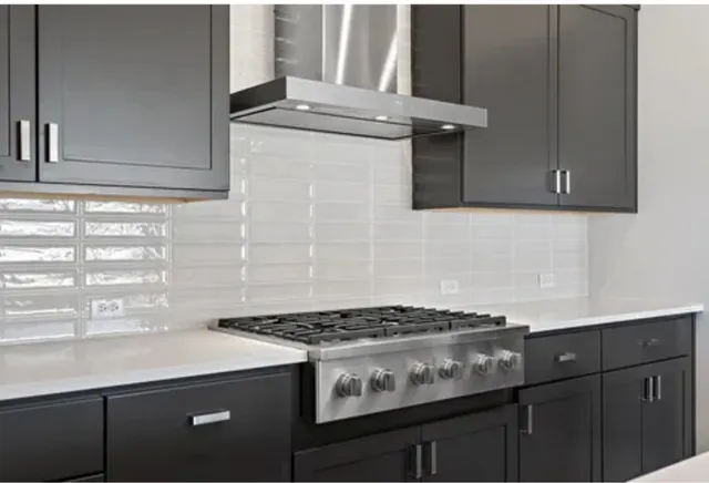 a kitchen with stainless steel appliances granite countertop a sink and a refrigerator
