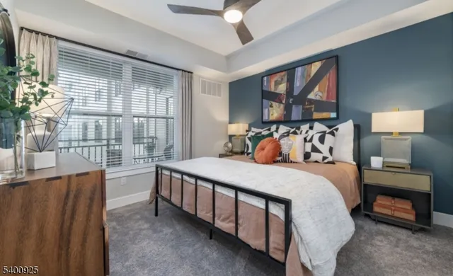 a bed sitting in a bedroom next to a window