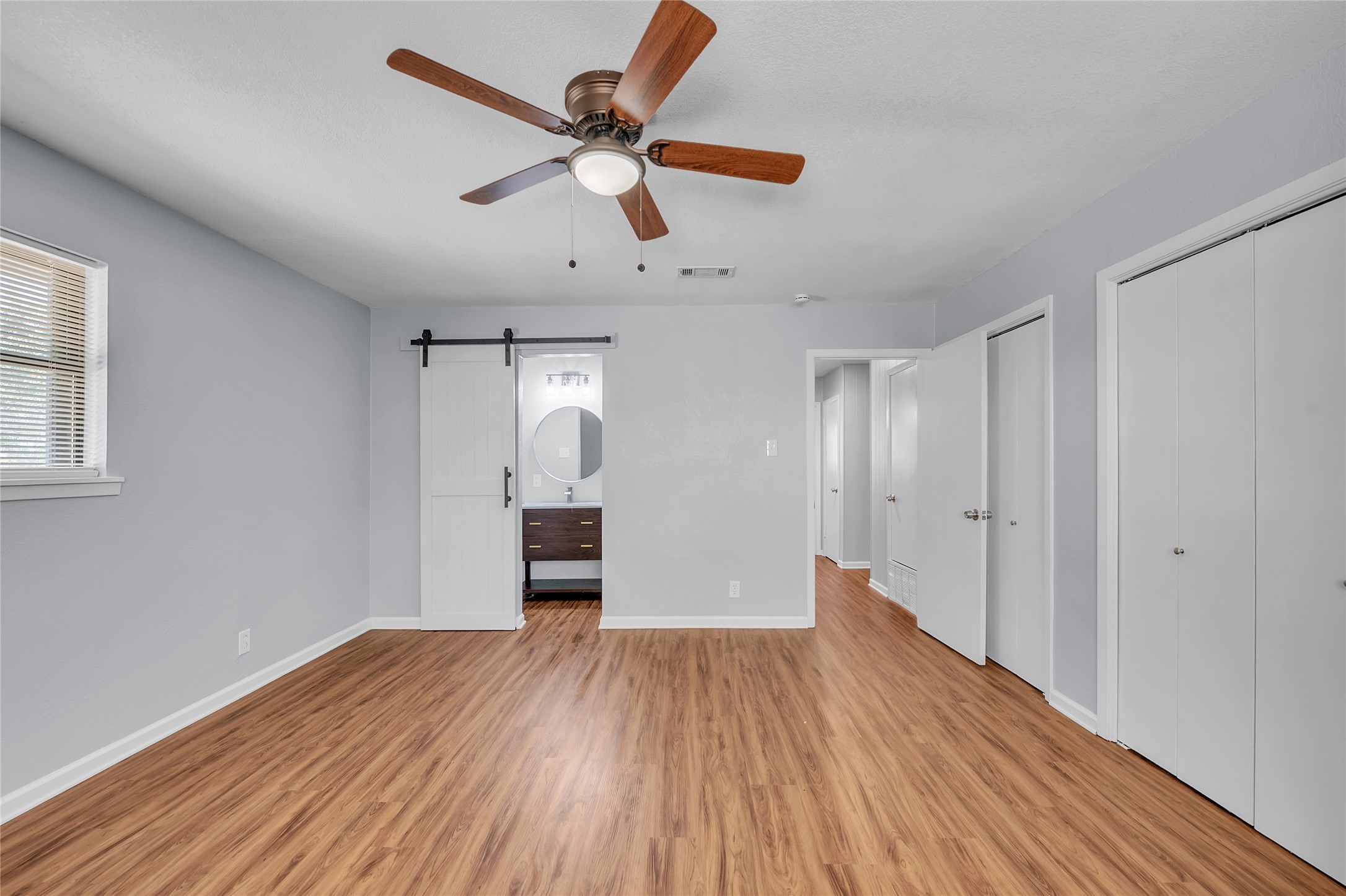 310 Hruskaville Road Temple, TX 76501 - Photo 12 of 18 Well-appointed bedroom with warm wood-tone flooring and a modern ceiling fan.