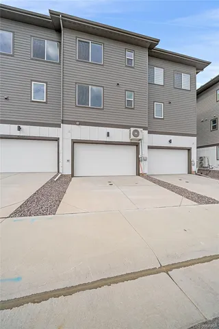 a front view of a building with a yard