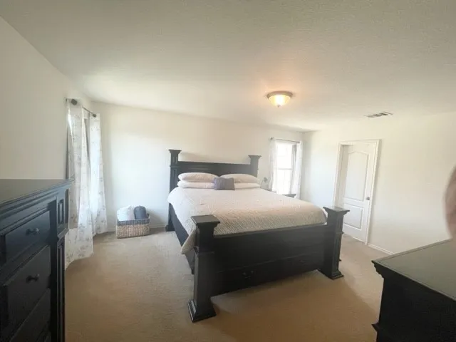 a bedroom with a bed and a mirror