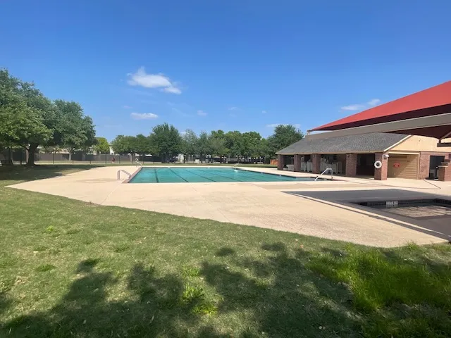 a view of lake with green yard