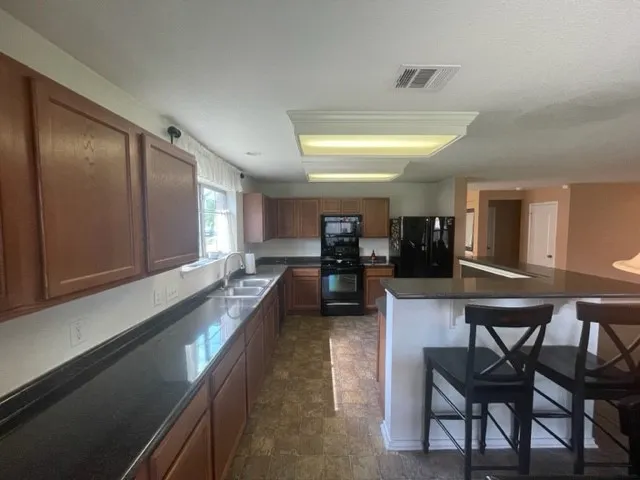 a large white kitchen with dining table and chairs