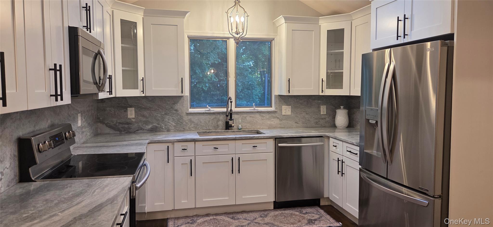 522 Moriches Road St. James, NY 11780 - Photo 14 of 49 a kitchen with white cabinets and stainless steel appliances