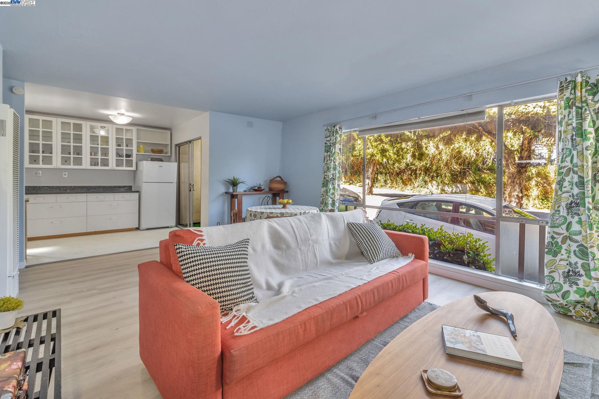 3877 Howe Street, Unit 106 Oakland, CA 94611 - Photo 1 of 17 a living room with furniture and a large window